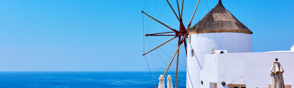 Old white windmill near sea in Santorini, Greece